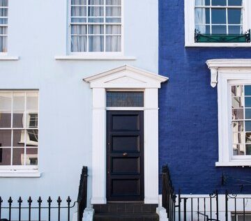 front-view-front-door-with-blue-wall_23-2149360642